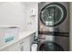 Clean laundry room featuring modern washer and dryer units with white cabinets at 3914 W Cleveland St, Tampa, FL 33609
