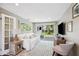 Comfortable living room featuring hardwood floors, modern furniture, and sliding glass doors with backyard view at 3914 W Cleveland St, Tampa, FL 33609