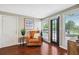 Cozy living room features hardwood floors, a leather chair, and bright natural light at 3914 W Cleveland St, Tampa, FL 33609