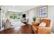 Inviting living room featuring hardwood floors, comfortable seating, and sliding glass doors to the backyard at 3914 W Cleveland St, Tampa, FL 33609