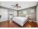 Cozy main bedroom features hardwood floors, ceiling fan, decor, and natural light at 3914 W Cleveland St, Tampa, FL 33609