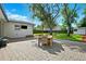 An expansive paved patio features an outdoor dining set in a lush backyard setting at 3914 W Cleveland St, Tampa, FL 33609