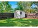 A backyard storage shed offers additional space, nestled in lush green surroundings at 3914 W Cleveland St, Tampa, FL 33609