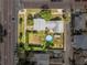 Aerial view of fenced backyard with a pool, boat, greenery and a detached garage at 4100 1St S Ave, St Petersburg, FL 33711