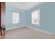 Bedroom painted baby blue is carpeted and has two windows for natural light at 4100 1St S Ave, St Petersburg, FL 33711