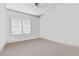 An empty bedroom offers neutral colors with carpeted floors and two windows at 4100 1St S Ave, St Petersburg, FL 33711