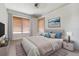 A bedroom with neutral colors and a ceiling fan has two windows at 4100 1St S Ave, St Petersburg, FL 33711