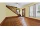 Inviting entryway featuring hardwood floors, staircase, decorative front door, and natural light from the windows at 4100 1St S Ave, St Petersburg, FL 33711
