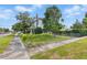 View of the two-story home's side, featuring a fenced yard with mature trees at 4100 1St S Ave, St Petersburg, FL 33711
