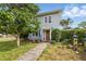 Charming home featuring a well-manicured lawn, sidewalk, mature trees, and a welcoming front door at 4100 1St S Ave, St Petersburg, FL 33711