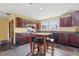 Eat in kitchen with tile floors, breakfast bar, wood cabinets, and abundant natural light at 4100 1St S Ave, St Petersburg, FL 33711