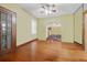 Open living room with hardwood floors, ceiling fan, windows and entryway featuring a tiled hallway at 4100 1St S Ave, St Petersburg, FL 33711
