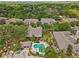 Overhead view of a community pool area surrounded by lush landscaping and townhomes, creating a relaxing oasis at 4105 Bismarck Palm Dr, Tampa, FL 33610
