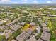 Overhead view of townhomes, highlighting the natural surroundings and community layout with an exact location marker at 4105 Bismarck Palm Dr, Tampa, FL 33610