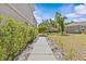 Backyard view highlighting a paved walkway, greenery, and neighboring townhomes at 4105 Bismarck Palm Dr, Tampa, FL 33610