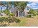 Backyard with screened lanai, mature landscaping, and a well-kept lawn at 4105 Bismarck Palm Dr, Tampa, FL 33610