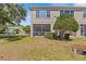 Backyard view showcasing the property's screened patio and well-maintained lawn at 4105 Bismarck Palm Dr, Tampa, FL 33610