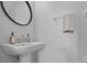 Stylish bathroom with a pedestal sink, modern fixtures, and a clean, minimalist design at 4105 Bismarck Palm Dr, Tampa, FL 33610