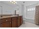 This bathroom offers a shower-tub combination, vanity, and tiled floor at 4105 Bismarck Palm Dr, Tampa, FL 33610