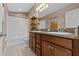 Bathroom features a double sink vanity with granite countertops and a shower-tub combination at 4105 Bismarck Palm Dr, Tampa, FL 33610