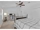 Spacious bedroom with a ceiling fan, a work desk, and ample natural light from two windows at 4105 Bismarck Palm Dr, Tampa, FL 33610
