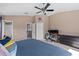 Bedroom offers a workspace, a ceiling fan, and access to the bathroom at 4105 Bismarck Palm Dr, Tampa, FL 33610