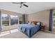 Bright bedroom features a large window, ceiling fan, and neutral walls, creating a comfortable space at 4105 Bismarck Palm Dr, Tampa, FL 33610