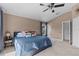 Spacious bedroom with a ceiling fan and a neutral color scheme for relaxation at 4105 Bismarck Palm Dr, Tampa, FL 33610