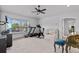 Bonus room equipped with exercise machines and a cozy seating area, perfect for relaxation at 4105 Bismarck Palm Dr, Tampa, FL 33610