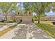 Charming two-story townhome featuring a two-car garage, mature trees, and a long driveway at 4105 Bismarck Palm Dr, Tampa, FL 33610