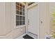 Front entrance showcasing a white door, adjacent window, and exterior details at 4105 Bismarck Palm Dr, Tampa, FL 33610
