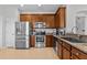 Modern kitchen with stainless steel appliances, granite countertops, and ample cabinetry at 4105 Bismarck Palm Dr, Tampa, FL 33610