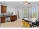 Bright kitchen with stainless steel appliances, granite countertops, and a dining table at 4105 Bismarck Palm Dr, Tampa, FL 33610