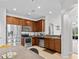 Bright kitchen with stainless steel appliances, wood cabinets, and an open view to the living area at 4105 Bismarck Palm Dr, Tampa, FL 33610