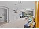 Spacious living room with carpet, ceiling fan, and sliding glass doors to the patio at 4105 Bismarck Palm Dr, Tampa, FL 33610