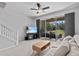 Inviting living room features a modern entertainment area, a comfortable couch, and screened lanai views at 4105 Bismarck Palm Dr, Tampa, FL 33610