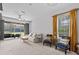 Bright living room with neutral tones, a comfortable seating area, and backyard views from screened lanai at 4105 Bismarck Palm Dr, Tampa, FL 33610