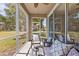 Relaxing screened patio with comfortable seating and a view of the lush green lawn at 4105 Bismarck Palm Dr, Tampa, FL 33610