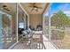 Cozy screened patio featuring outdoor seating and serene views of the green surroundings at 4105 Bismarck Palm Dr, Tampa, FL 33610