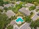 Aerial view of a community pool with lounge chairs and lush tropical landscaping, offering a relaxing and inviting amenity at 4105 Bismarck Palm Dr, Tampa, FL 33610