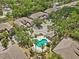 Aerial view of a community pool surrounded by lush landscaping, palm trees, and inviting lounge chairs, perfect for relaxation at 4105 Bismarck Palm Dr, Tampa, FL 33610