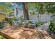 Cozy backyard deck with white metal furniture and lush landscaping, perfect for outdoor relaxation and dining at 4124 W San Juan St, Tampa, FL 33629