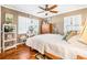 Bright bedroom with hardwood floors, a ceiling fan, and a well-lit vanity area at 4124 W San Juan St, Tampa, FL 33629