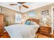 Cozy bedroom featuring a ceiling fan, a wooden bed frame, and hardwood flooring at 4124 W San Juan St, Tampa, FL 33629