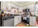 Well-maintained kitchen featuring white cabinetry, stainless steel appliances, and a functional layout at 4124 W San Juan St, Tampa, FL 33629