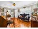 Cozy living room featuring hardwood floors, vintage furniture, and natural light streaming through plantation shutters at 4124 W San Juan St, Tampa, FL 33629