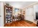 Living room with hardwood floors, a ceiling fan, and a dark wood bookcase and desk at 4124 W San Juan St, Tampa, FL 33629