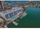 Aerial view of waterfront condo, community pool, private docks, and boat slips in a beautiful waterfront community at 415 Island Way # 511, Clearwater Beach, FL 33767