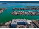 Breathtaking aerial view of waterfront condos with boat docks and turquoise waters in a beautiful neighborhood at 415 Island Way # 511, Clearwater Beach, FL 33767