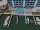 Aerial view featuring condo pool, docks, and waterfront access at 415 Island Way # 511, Clearwater Beach, FL 33767